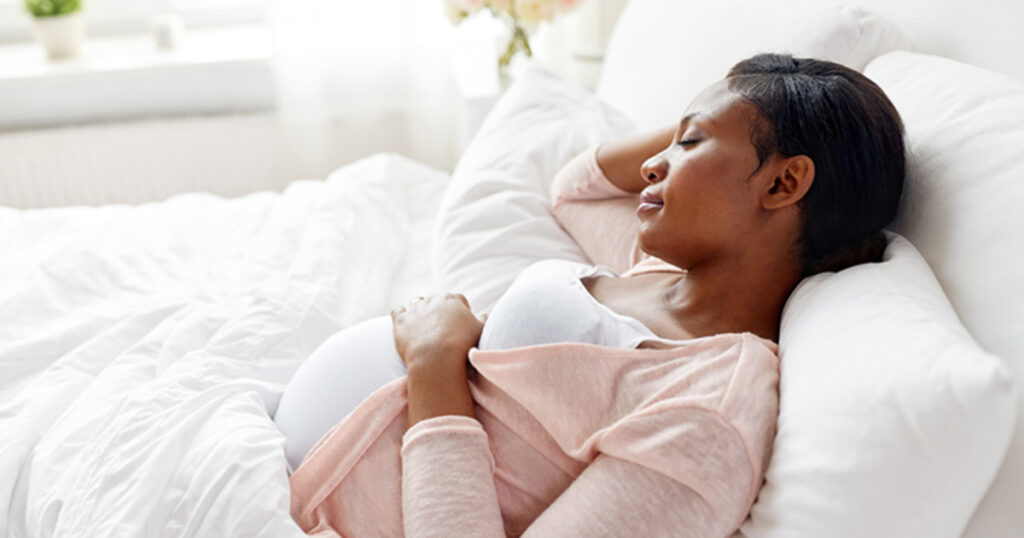 pregnant african american woman sleeping at home