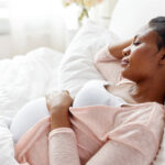 pregnant african american woman sleeping at home