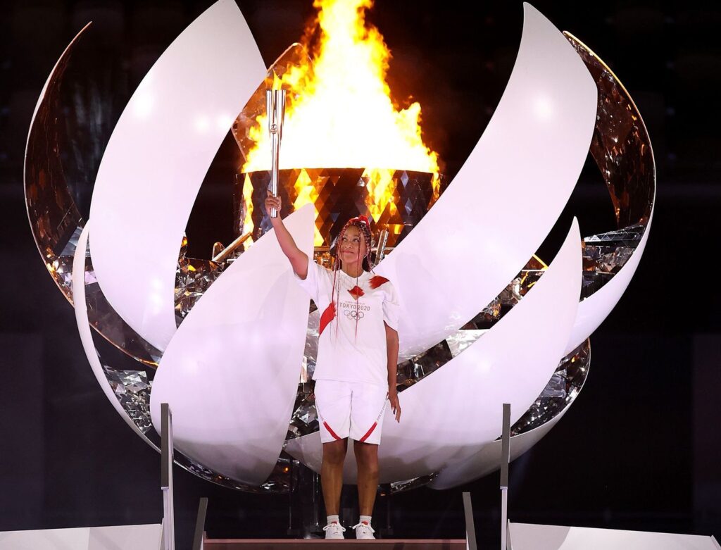Naomi Osaka holds the Olympic torch in Tokyo.