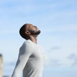 Man with black skin relaxing breathing fresh air outside