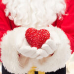 Santa-holding-a-heart-shaped-decoration-Photo-by-Ground-Picture-on-Shutterstock