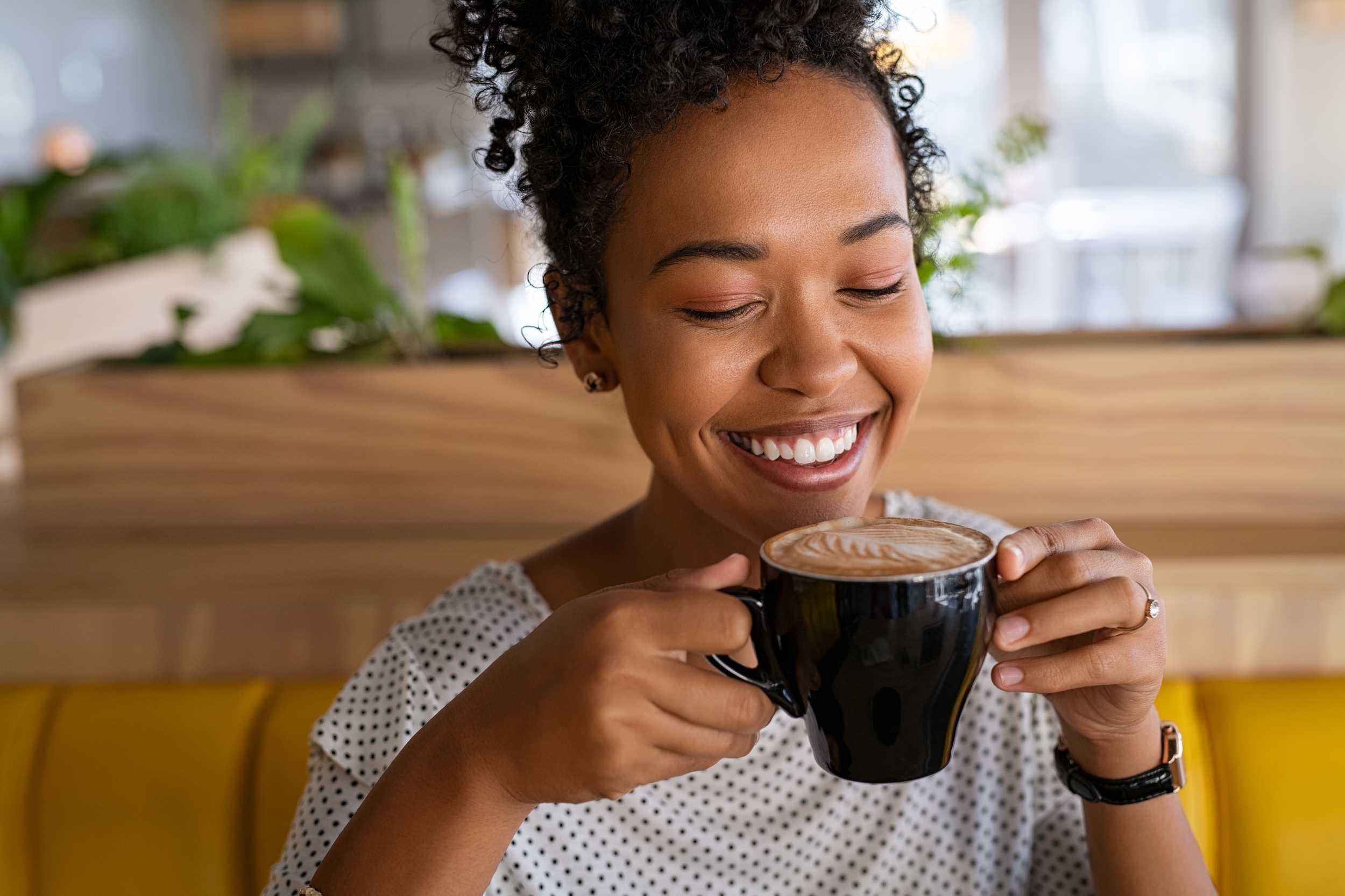 Woman-enjoying-a-latte-Photo-by-Ground-Picture-on-Shutterstock