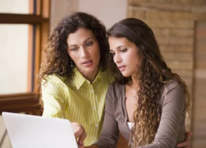 Mother and daughter reviewing college admissions decisions. Credit: Ariel Skelley/Getty Images