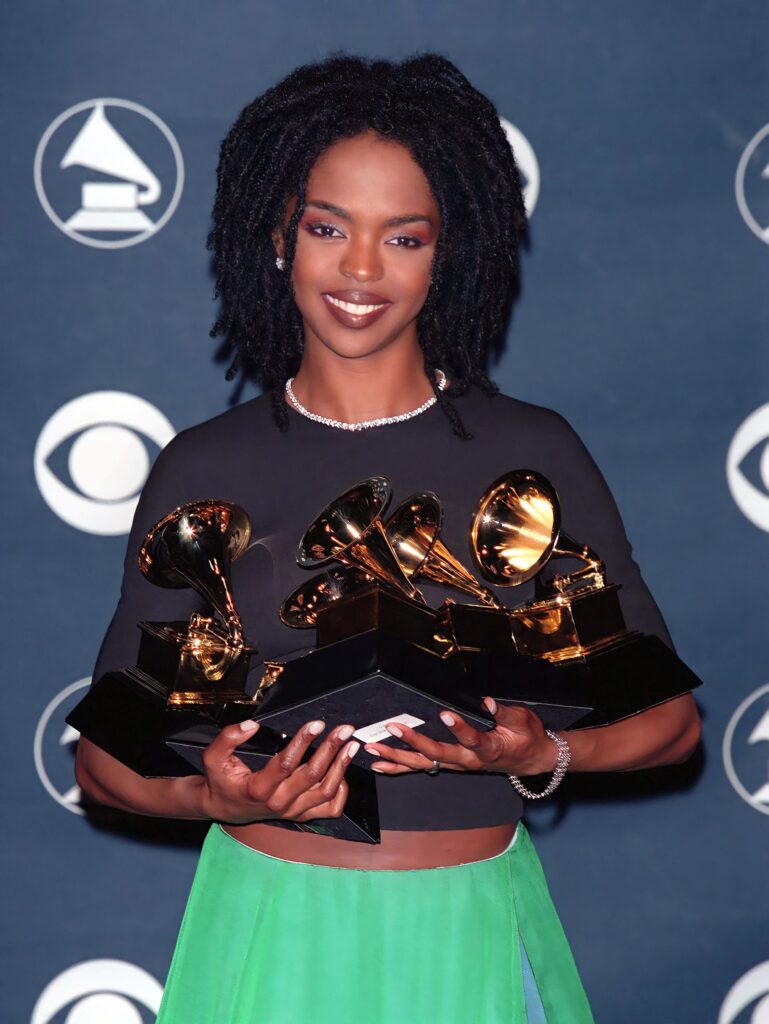 Lauryn Hill holding her five Grammy awards during the 1998 Grammy Awards.