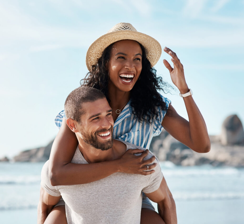 A couple enjoying their time at the beach (Credit: Photo by PeopleImages.com - Yuri A via Shutterstock)