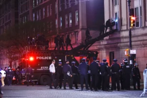 NYPD officers in riot gear break into a building at Columbia University, where pro-Palestinian students are barricaded inside a building and have set up an encampment, in New York City on April 30, 2024. Credit: Kena Betancur/AFP/Getty Images