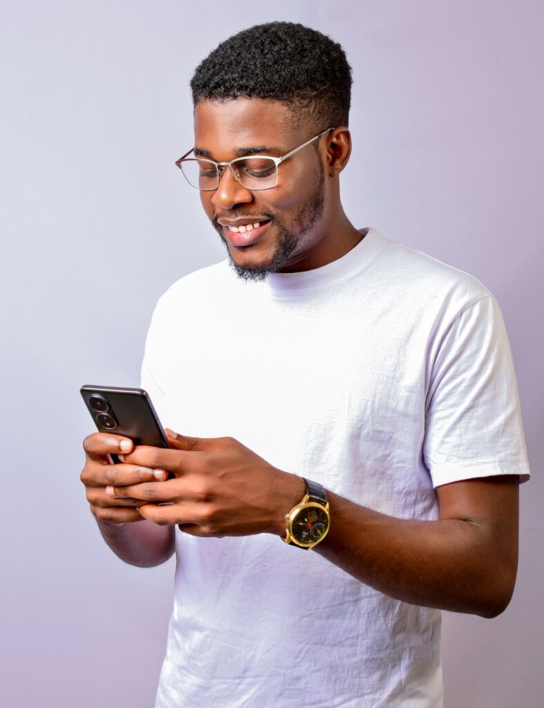 Man scrolling on his phone as part of a roundup of smart influencers to follow. (Credit: Maiye Jeremiah via Unsplash)