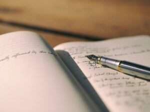Writing in a journal/diary (Credit: Aaron Burden via Unsplash)