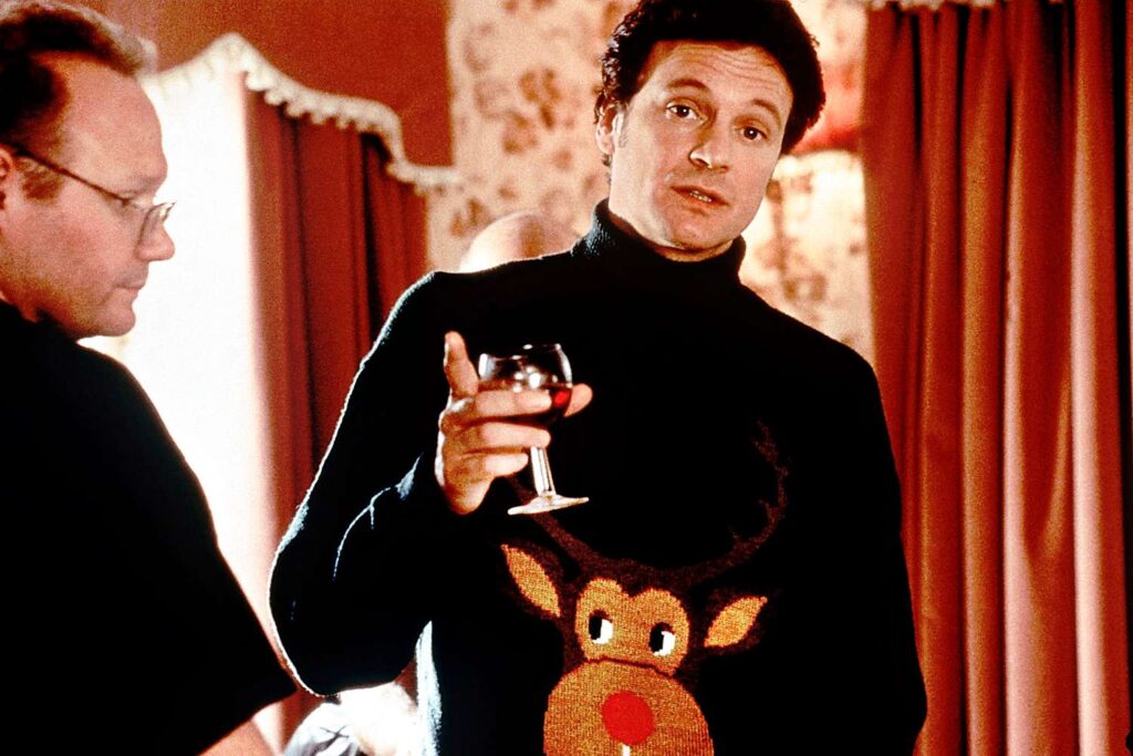 Colin Firth as Mark Darcy in the 2001 film, "Bridget Jones's Diary" as part of a guide on ugly holiday sweaters (Credit: Everett Collection)