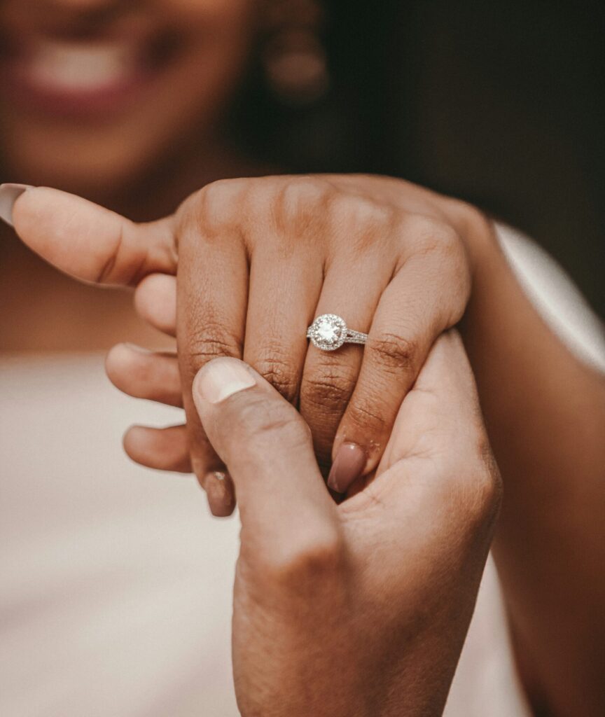 Woman wearing her engagement ring as part of a guide on tips for buying an engagement ring. (Credit: Alekon pictures via Unsplash)