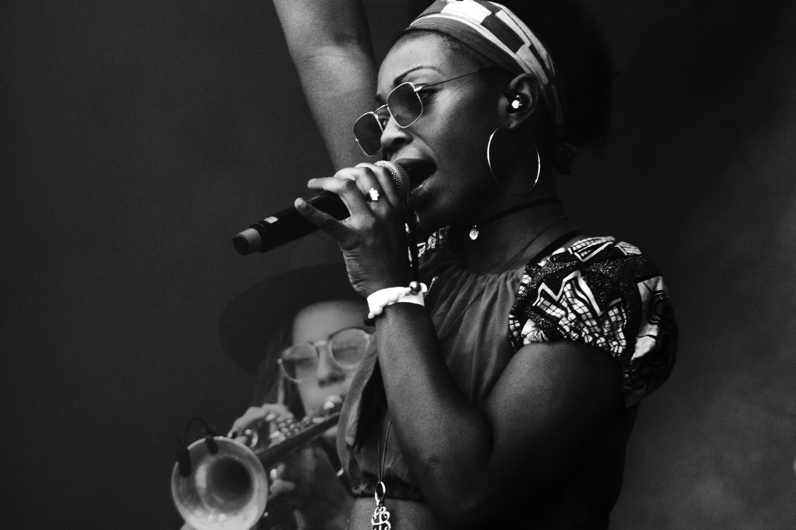 A Back woman speaking in front of an audience as part of a story explaining why Gen Z culture is Black culture. (Credit: Julius Drost via Unsplash)