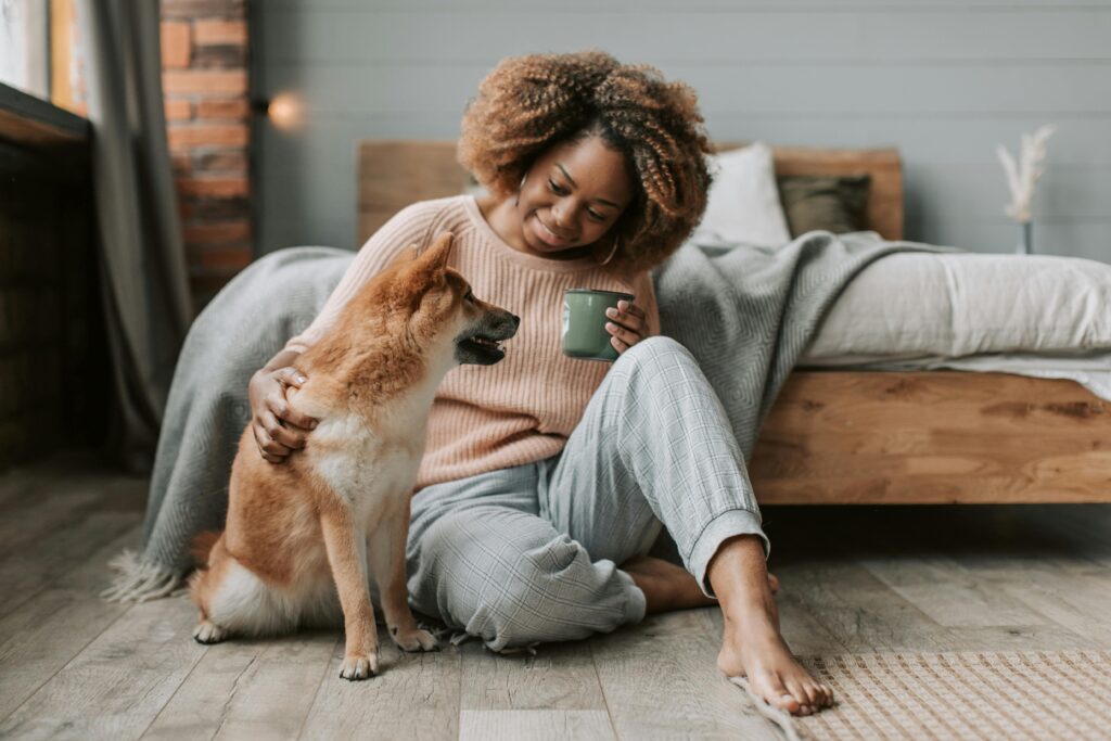 A woman with her dog as part of a story on what to expect when getting a pet. (Credit: Vlada Karpovich via Pexels)