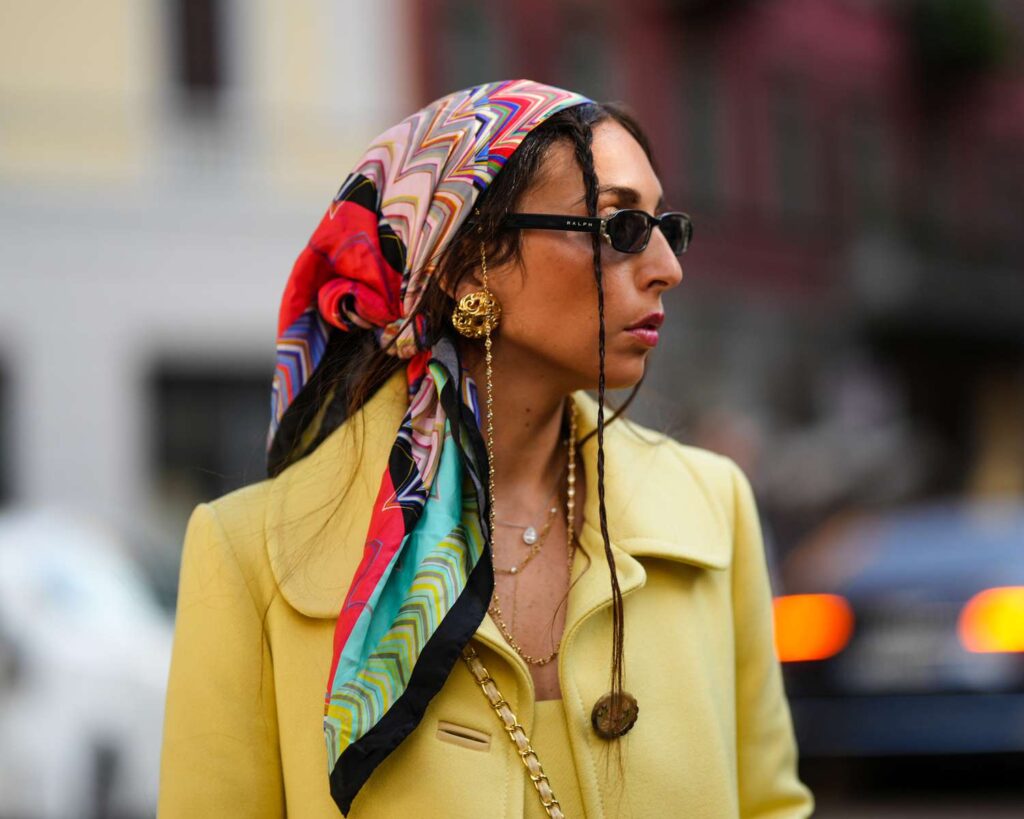 A woman wearing a silk scarf as part of a story on the hottest spring fashion trends of 2026. (Credit: InStyle)